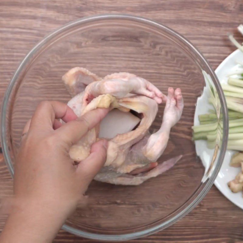 Step 3 Stuff the ingredients into the chicken's belly and secure Chicken soaked in fish sauce