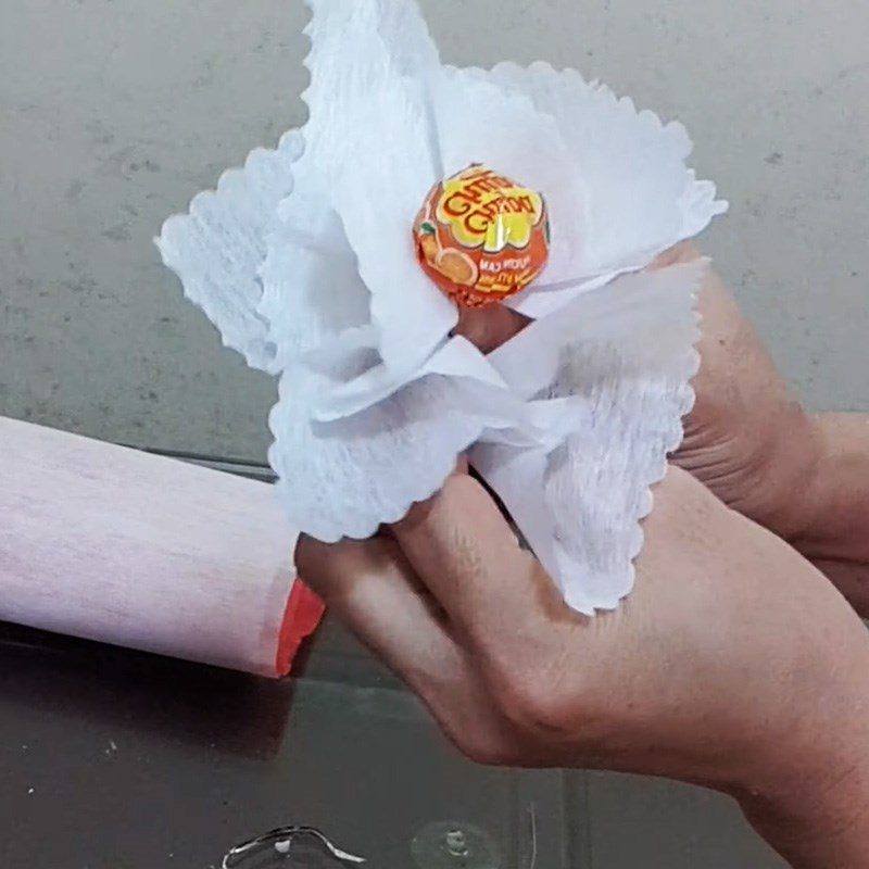 Step 2 Wrap with paper and insert flowers Bouquet from lollipop