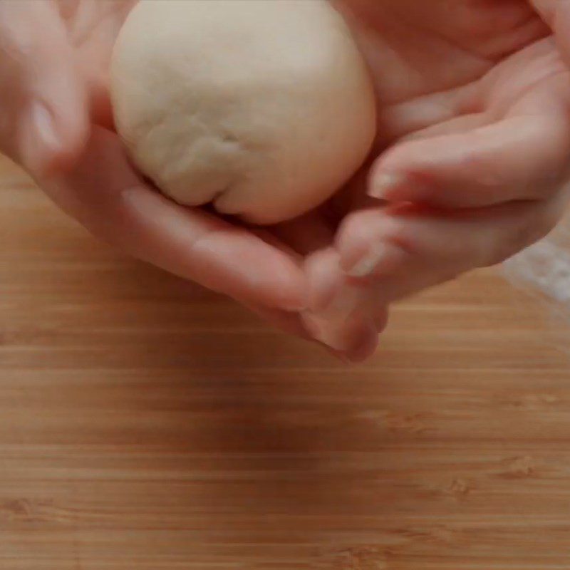 Step 5 Roll out the dough and wrap the mango custard filling Mango custard bun