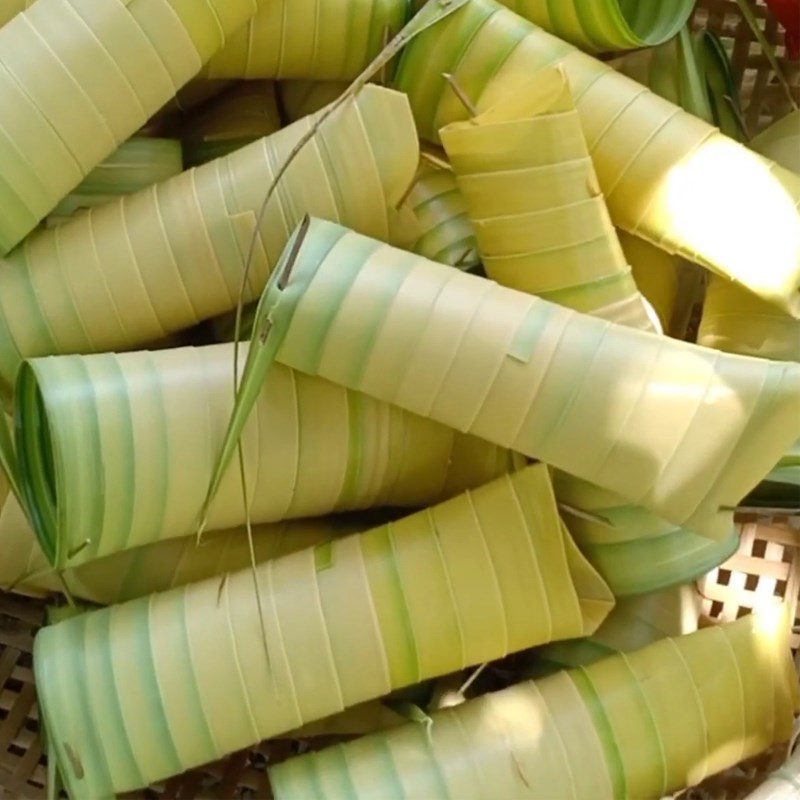 Step 2 Rolling coconut leaves to wrap the cake Coconut leaf cake Ben Tre