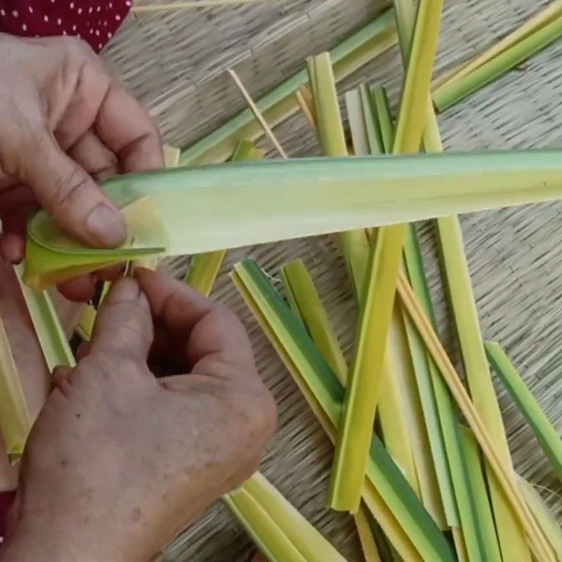 Step 2 Rolling coconut leaves to wrap the cake Coconut leaf cake Ben Tre