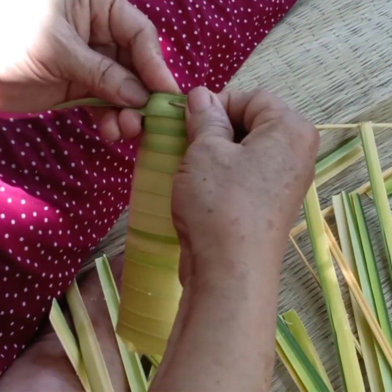 Step 2 Rolling coconut leaves to wrap the cake Coconut leaf cake Ben Tre